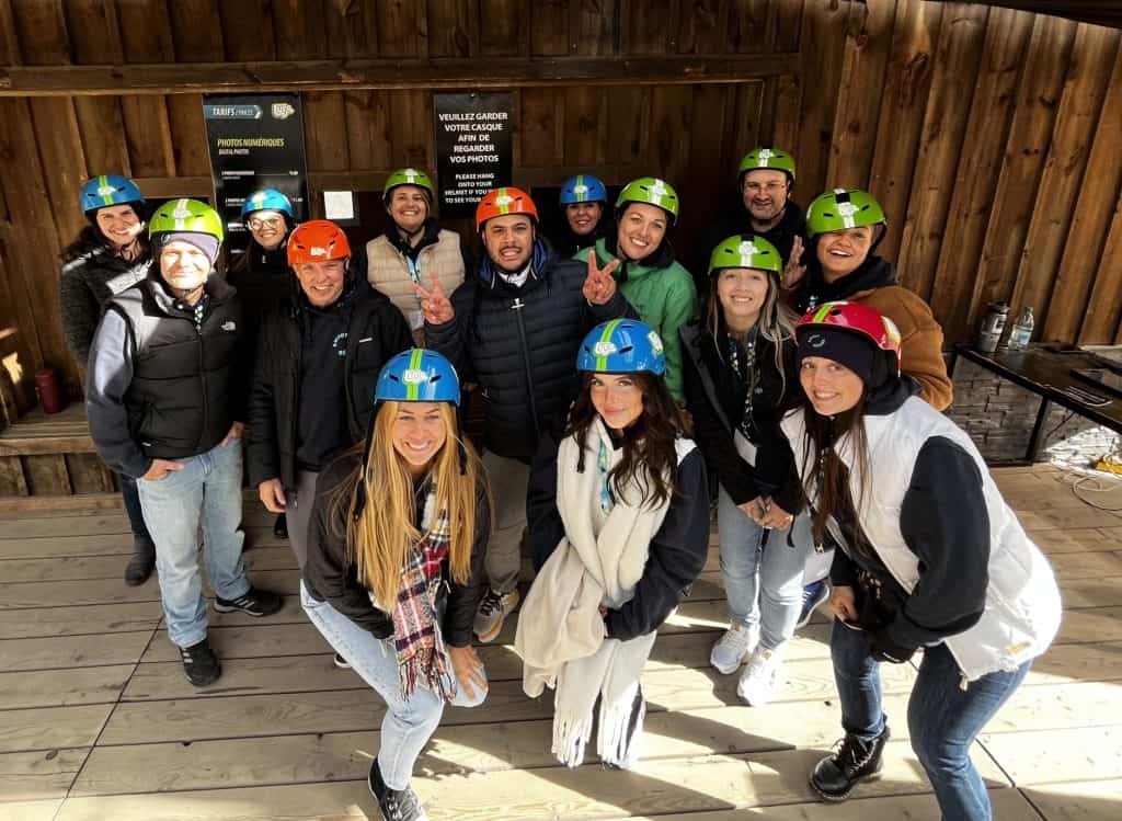Group of people wearing ski helmets, ready for a mountain activity or outdoor adventure, friendly atmosphere, nature, winter sports, jovial team, group activity, mountain entertainment, Relevance.